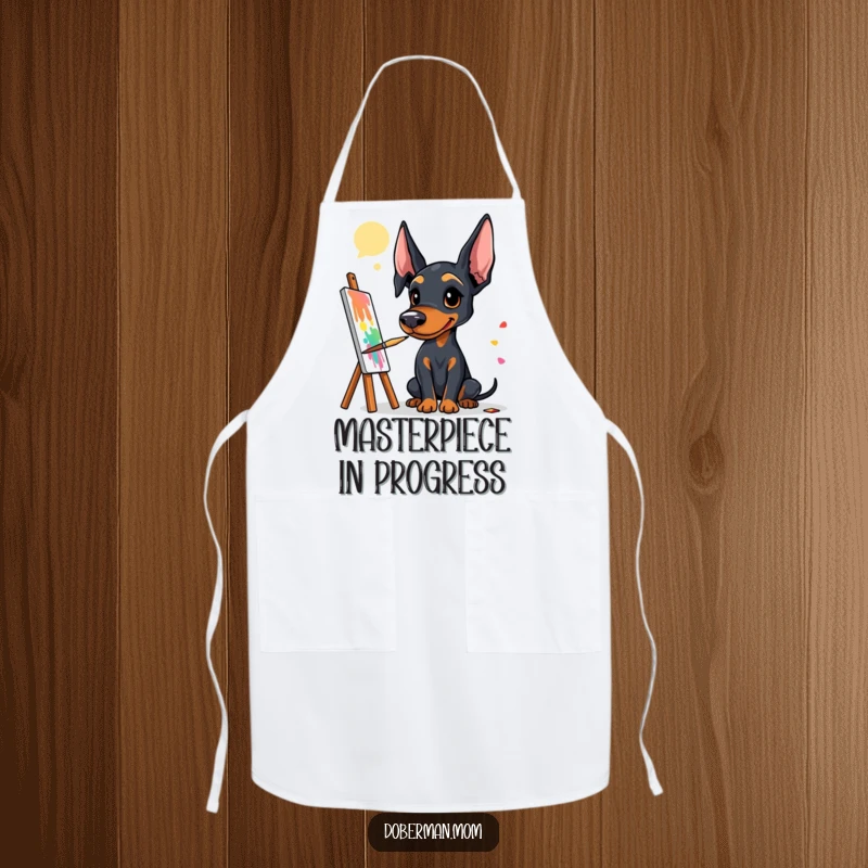 Funny Doberman artist apron with a dog holding a paintbrush, ready to create a colorful and vibrant painting.