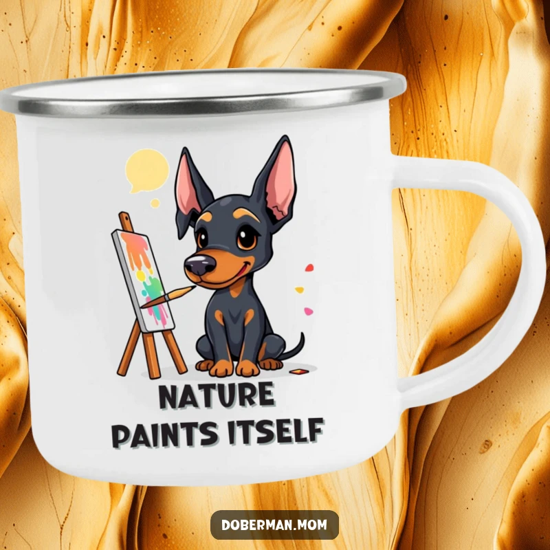 Funny Doberman artist camping mug showing a dog with a paintbrush, creating art in an outdoor setting.