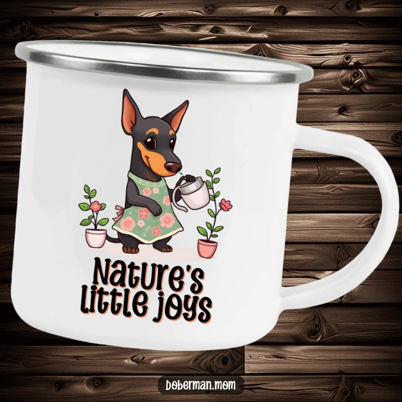 Funny Doberman Gardener Camping Mug of a Doberman dog in a floral apron, watering a small plant outdoors.