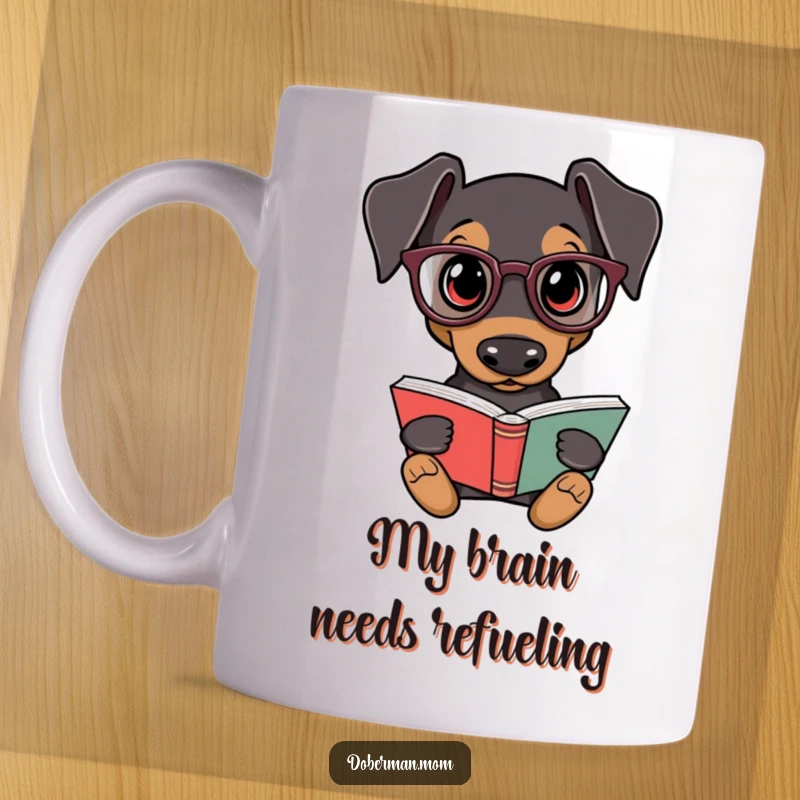 Funny Doberman Mug: A scholarly Doberman in tiny glasses reads a book, exuding intelligence and humor. Perfect gift for book lovers.
