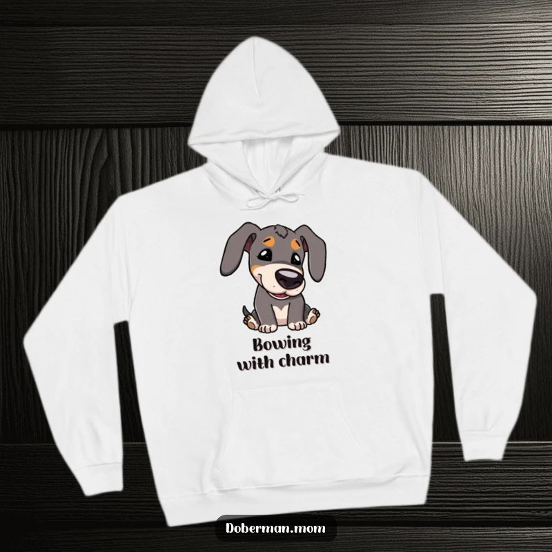 Funny Hoodie: Kawaii Doberman character with big eyes, playfully bowing its head, offering cozy, sweet charm.