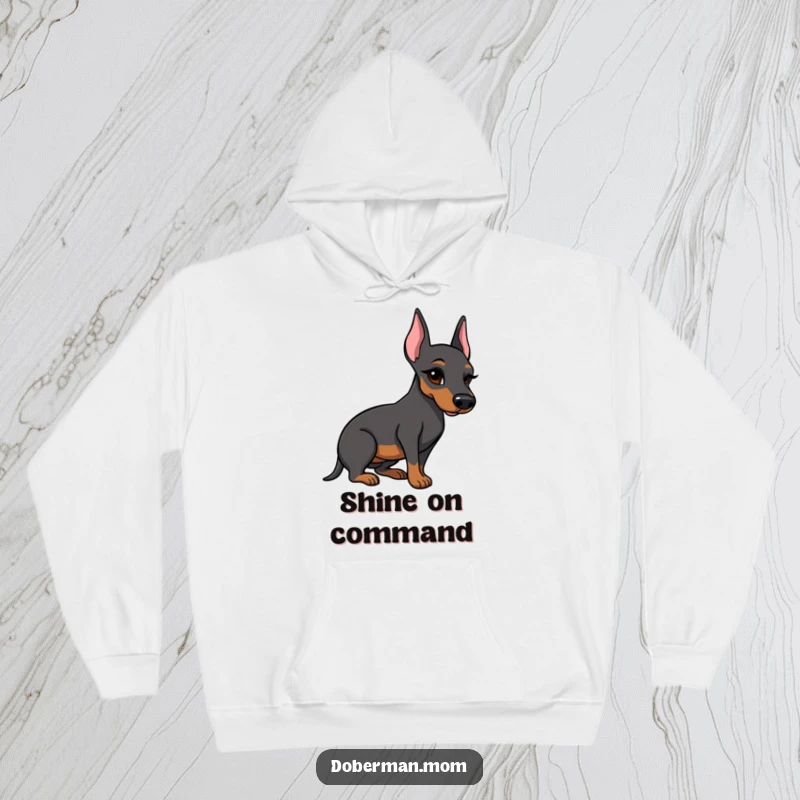 Funny Doberman hoodie with a winking dog proudly presenting a meticulously polished boot, combining comfort and humor.
