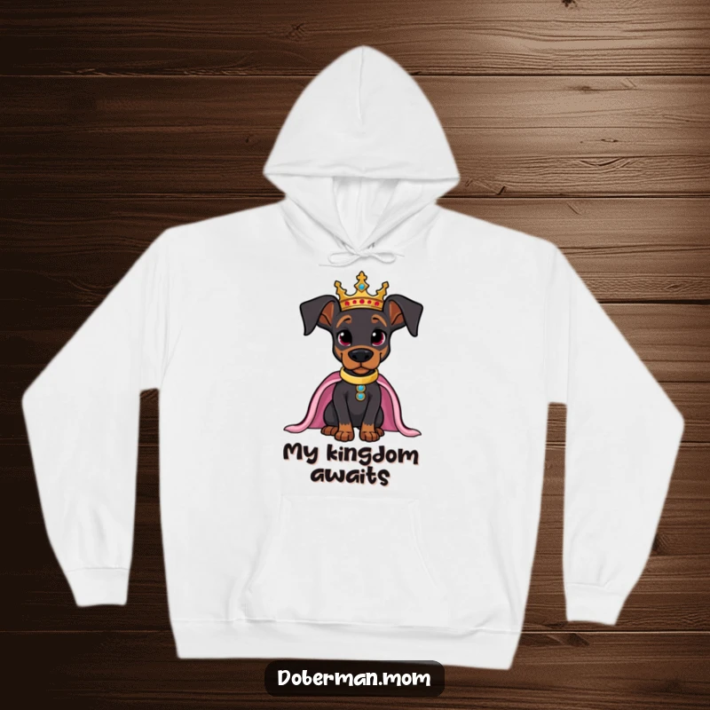 Funny Doberman hoodie, adorned with a regal crown, posing confidently like a king or queen.