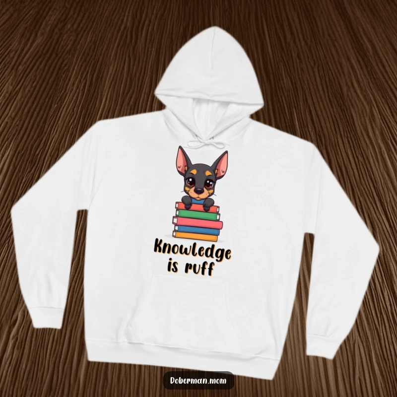 Funny Doberman Book Stack Hoodie featuring a determined dog balancing books; cozy and humorous apparel for passionate readers.