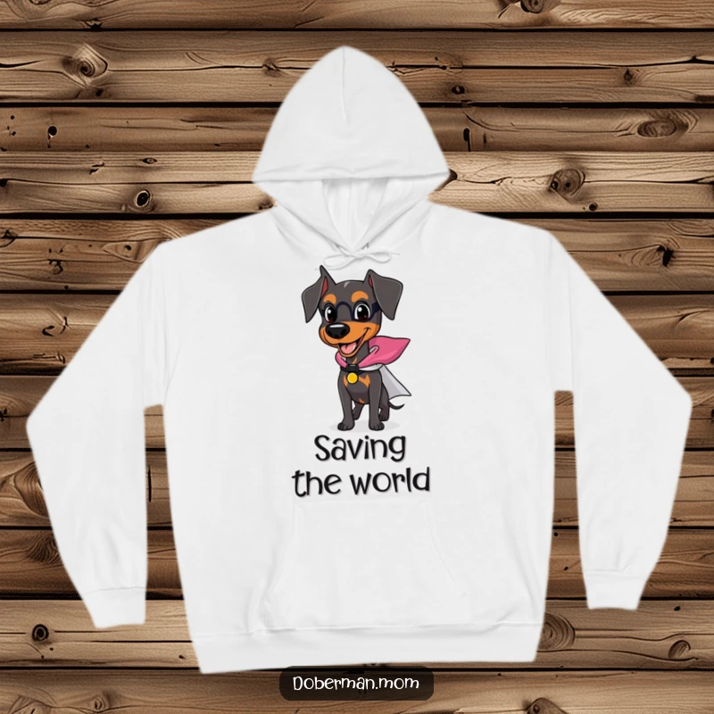 Funny Doberman hoodie featuring a happy dog wearing a tiny superhero cape, ready for action and cozy adventures.