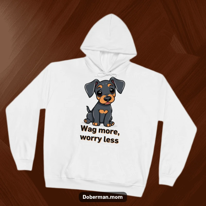 Funny Doberman hoodie featuring an alert dog gently wagging its tail, offering cozy warmth and a symbol of subtle, happy affection.