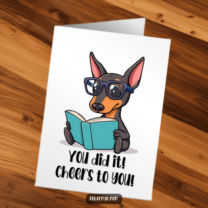 Funny Free Printable Congratulations Card: Doberman with reading glasses, holding a book, signifying a well-deserved accomplishment.