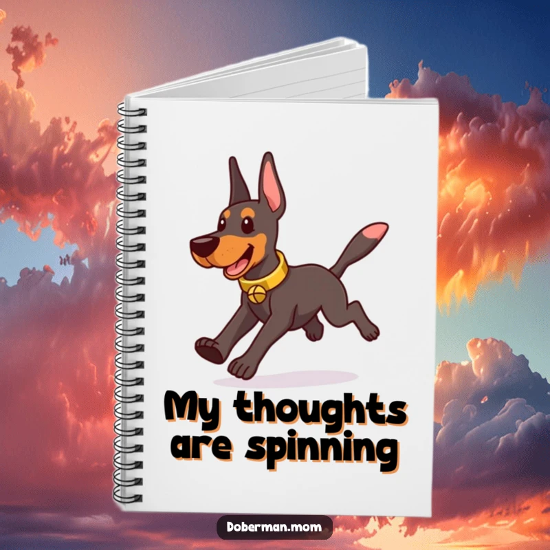 Funny Doberman wearing a tinkling bell collar, playfully chasing its tail, featured on a notebook cover.