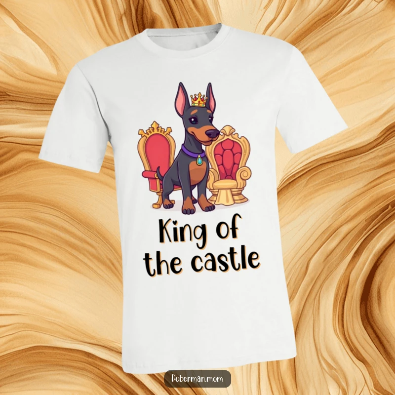 Funny Doberman T-shirt showing a proud Doberman with a tiny crown next to a miniature throne, celebrating canine majesty.