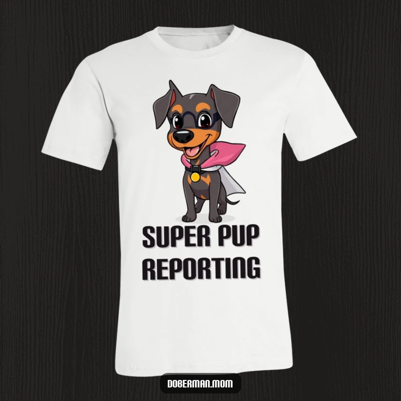 Funny Doberman t-shirt with a happy dog wearing a small superhero cape, appearing brave and ready for action.