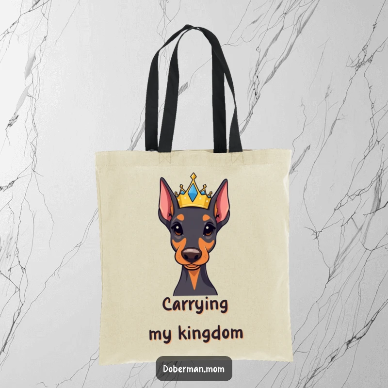 Funny Regal Doberman tote bag wearing a small, jeweled crown, perfect for carrying essentials with majestic humor and doggy dignity.