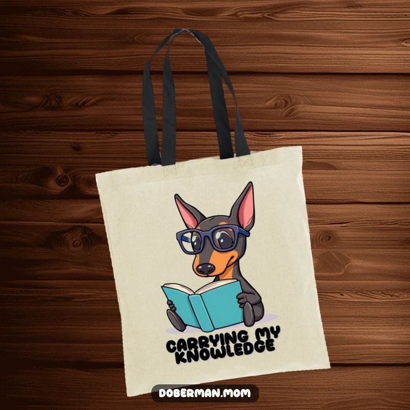 Funny Doberman Tote Bag featuring a Doberman dog wearing reading glasses, holding a book, ready for a literary adventure.