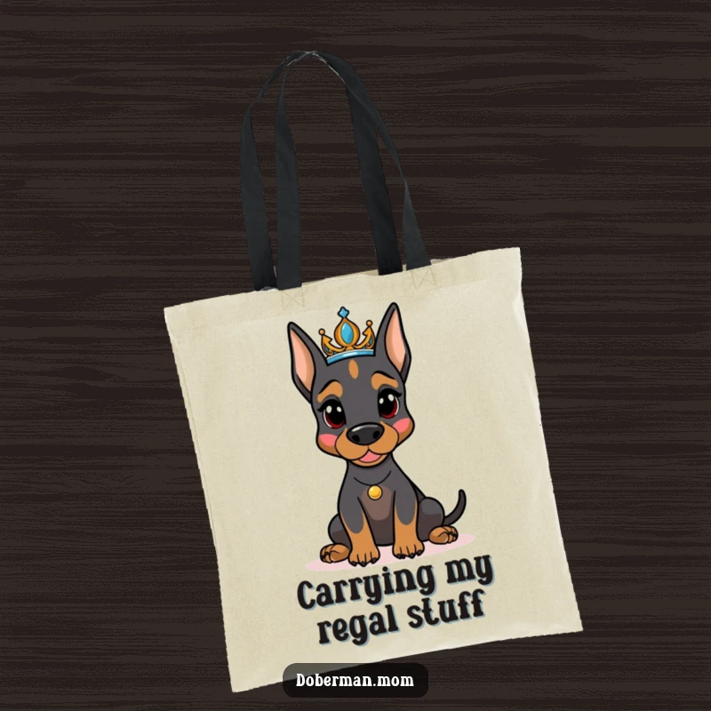 Funny regal Doberman dog wearing a tiara, confidently posing on a stylish tote bag, a humorous accessory for dog moms.